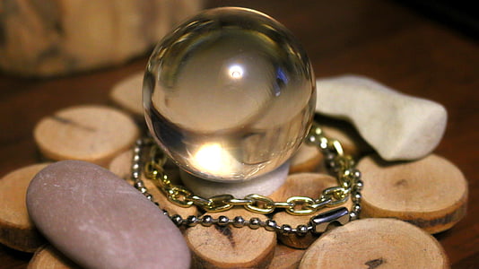 selective focus photography of crystal ball on round brown surface thumbnail