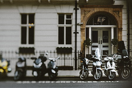 Eight Assorted Motorcycles Parked on Concrete Floor thumbnail