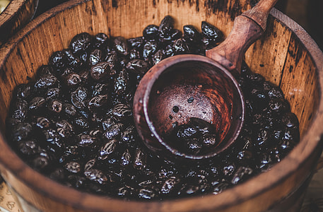 brown wooden bucket with prune fruits \ thumbnail