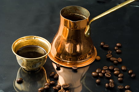brown steel container beside coffee beans thumbnail