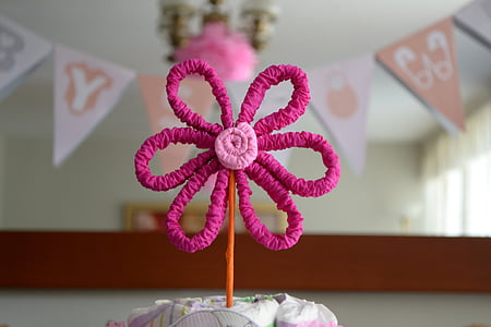 pink flower decor beside buntings thumbnail