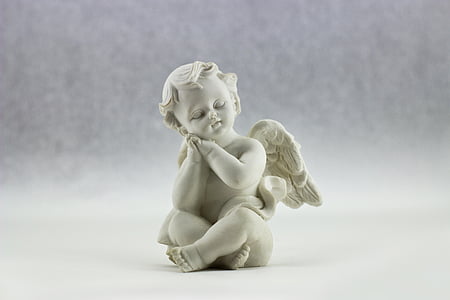 shallow focus photography of angel figurine thumbnail