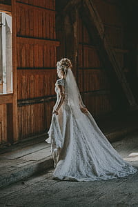 woman wearing white wedding gown looking at the window thumbnail
