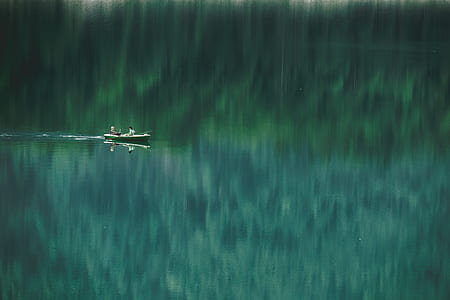 landscape photography of two person ride on boat thumbnail