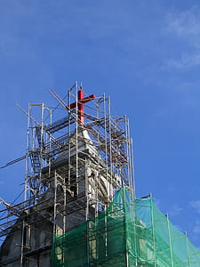 -- red cross with scaffolding against a blue sky thumbnail