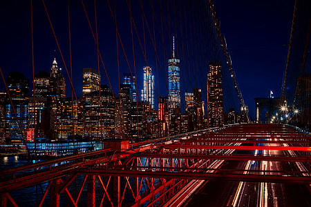 time lapse and light streaks photo of cars on the bridge with high rise buildings as background thumbnail