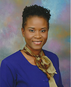 woman in blue long-sleeved dress and green scarf thumbnail