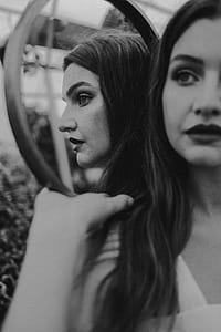 grayscale photography of woman reflected on mirror thumbnail