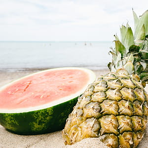 Sliced Watermelon and Pineapple Near Seashore thumbnail