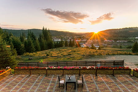 photography of table and two chairs beside bench outside at golden hour thumbnail