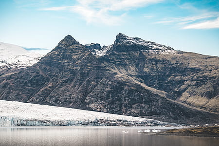 landscape photo of body of water in front of mountain thumbnail