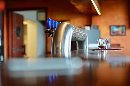 tilt-shift photography of clear shot glass on brown bar counter thumbnail