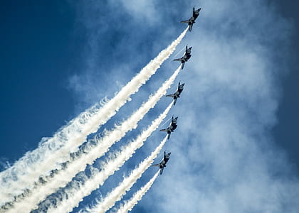 time lapse photography of five plane contrails thumbnail