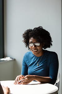 Woman Wearing Black Framed Eyeglasses and Blue Crew-neck Elbow-sleeved Top thumbnail
