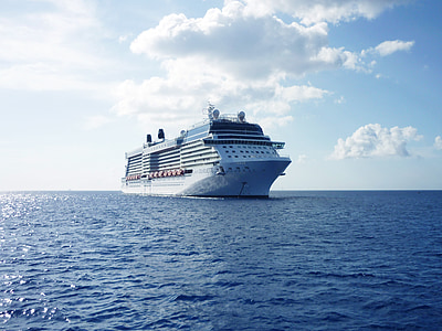 photo of white and blue crew ship sailing on sea thumbnail