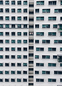 white concrete building with green windows thumbnail