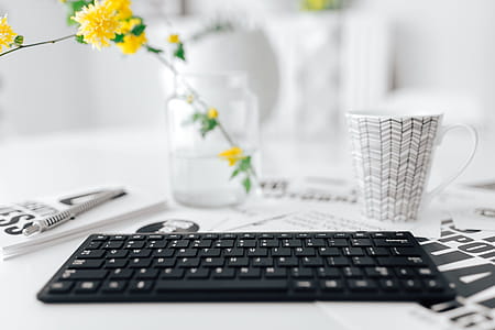 Female hands typing on the remote wireless computer keyboard thumbnail