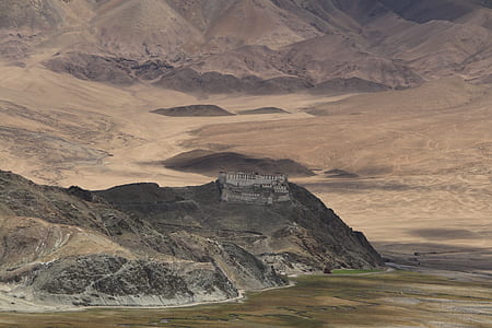 aerial photography of castle on mountain top thumbnail