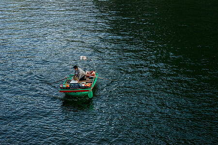 person riding jon boat on calm body of water thumbnail