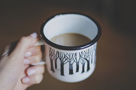 person holding white and black ceramic cup thumbnail