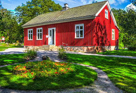 red wooden house surrounded with trees thumbnail