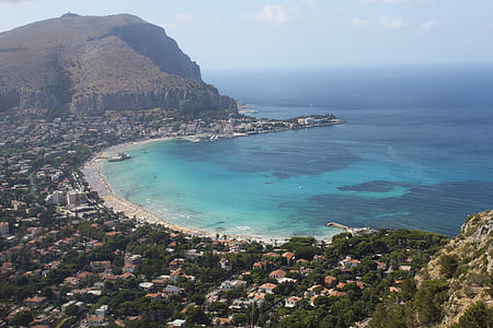 body of water with mountain in vicinity thumbnail