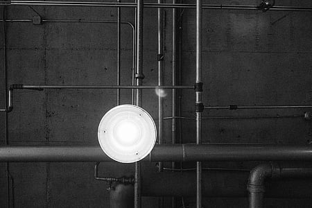 lighted white light bulb beside gray pipes thumbnail