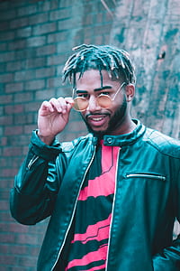 man wearing black leather jacket and sunglasses thumbnail