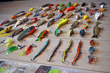 close-up photo of assorted-color fish lure lot on brown wooden surface thumbnail