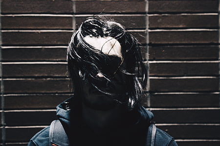 person standing near brown wall thumbnail