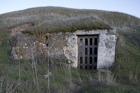 concrete tunnel with wooden doors on mountain thumbnail