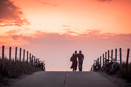 couple walking on road during sunset thumbnail