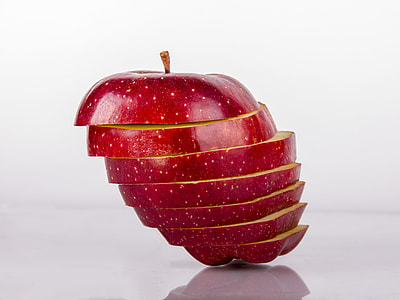 horizontal sliced red apple on white surface thumbnail