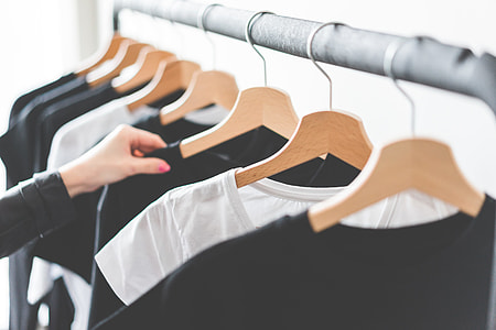 Woman Choosing T-Shirts During Clothing Shopping at Apparel Store #2 thumbnail