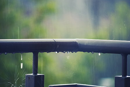 black metal fence during rainy day thumbnail