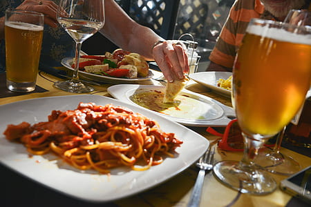 spaghetti on square white ceramic plate beside stainless steel fork thumbnail