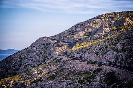 mountain pass under cloudy sky during daytime thumbnail
