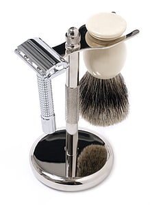 silver razor and shaving foam brush on silver metal stand thumbnail
