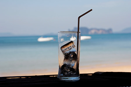selective focus photography of  clear pint glass with three ice cubes inside thumbnail