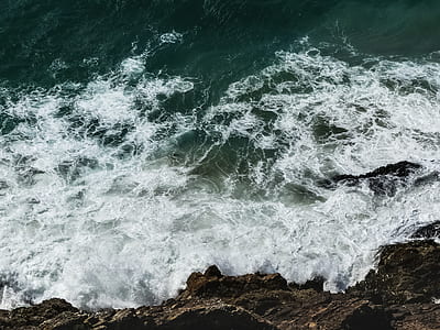 sea waves hitting rock formation thumbnail