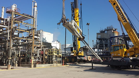 yellow Wagstaff crane holding gray metal part at daytime thumbnail
