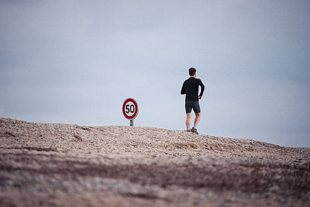 man standing beside signage thumbnail