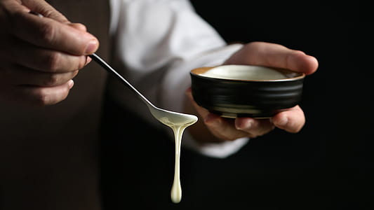 person holding bowl and spoon thumbnail