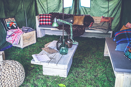 green goose lamp on rectangular gray wooden coffee table inside of tent thumbnail