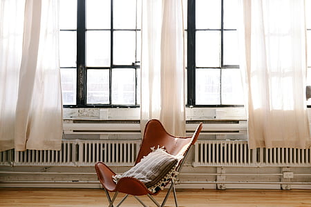 white and gray chair near glass windows thumbnail