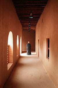 man walking at the middle of isle beside concrete wall thumbnail