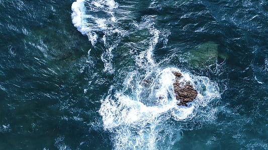 brown stone and body of water thumbnail