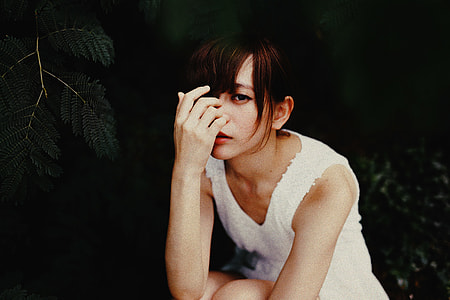 woman sitting while holding her nose thumbnail