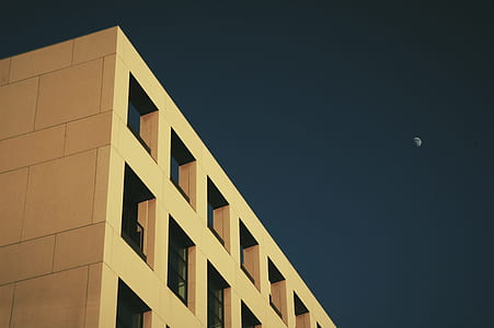 worms eye view of building and quarter moon thumbnail