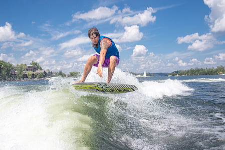 man riding surfboard during daytime thumbnail